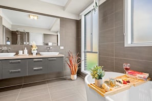 Wash your troubles away in the luxurious bathroom with a soaker bathtub, walk-in shower, and a double vanity.