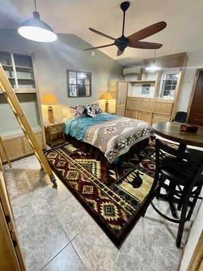 Wake up to garden views in this cozy queen bed with southwestern charm.