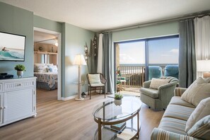 Sunlit living space featuring natural light, comfy seating, and a private balcony.