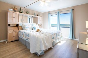Elegant master bedroom with king size bed, ocean views, soft linens, and a peaceful ambiance.