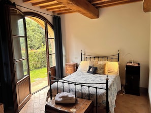 The second bedroom has a queen-size bed and 'French' doors leading outside to a small patio...