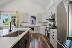 Sleek, spacious kitchen with stunning stainless steel appliances—made to impress and built to entertain.