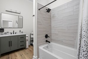 Bathroom 2: Enjoy a sleek bathroom with modern fixtures and a luxurious tub for ultimate relaxation!