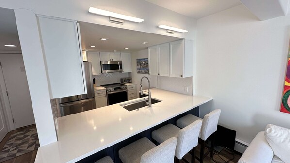 Kitchen with white quartz countertops