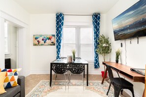 A blend of textures and colors creates a welcoming atmosphere.  The intricate patterns on the rug and curtains add depth to the space.