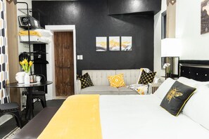 Well-designed bedroom with a comfortable sofa and a large bed, perfect for relaxation.