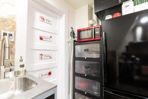 The kitchen's calming ambiance is enhanced by the warm lighting and decorative elements.
