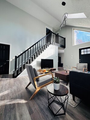 Main living room with 50 inch Smart TV and sofa,chair and table…