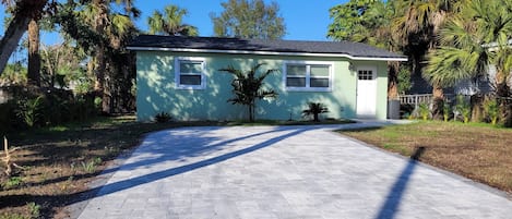 House has new large, wide paver driveway