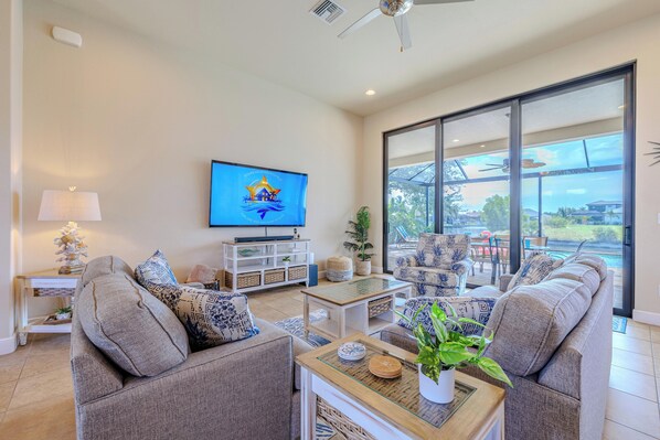 Bright Escape - - Lounge in a sunlit living room with cozy seating and serene canal views
- Catch up on your favorite shows with a smart TV or simply enjoy the peaceful ambiance
- Experience the perfect harmony of comfort and relaxation in this inviting space