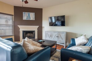 Cozy living room with a fireplace and comfy couch (1)