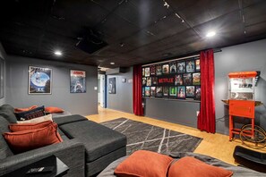 Private movie room with ample seating, a large projection screen, and your own popcorn machine—perfect for a cinematic experience at home!