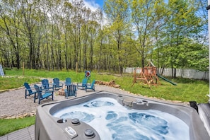 Enjoy ultimate relaxation in the outdoor hot tub, perfectly positioned to overlook the pool and cozy fire pit area—ideal for unwinding under the stars!