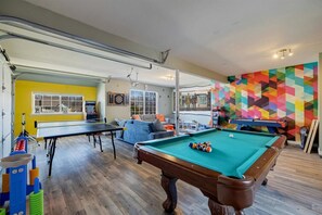 Game on! Enjoy endless entertainment in our game room, featuring a ping pong table, pool table, movie projection screen, classic arcade games, a popcorn machine, and more fun activities for everyone to enjoy!