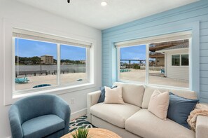 Relax and unwind in this cozy living room with stunning beach views right outside your window! 🌊☀️ #BeachfrontRetreat #OceanViews