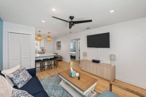 Open-concept living space with the kitchen just beside the cozy living room, creating a seamless flow for both cooking and relaxation.
