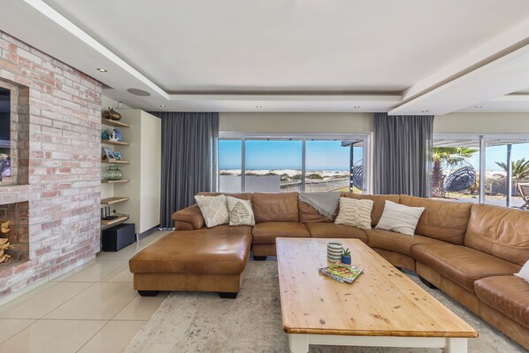Big leather sofa provides ample space for guests to sit.