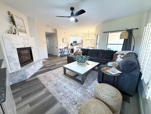living space with smart tv, fireplace, and huge sofa