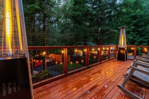 Upper Deck/Balcony off Bedroom 2.  Large Pyramid Propane Heaters to keep warm on chilly evenings!  The rocking chairs have been replaced with comfy cushioned sectional sofa, ottoman and coffee table.