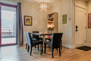 The dining area includes a bookshelf stocked with board games and books for all ages.