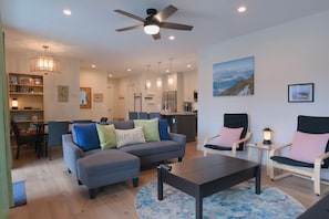 The living room features a comfortable couch that easily converts into a sofa bed.