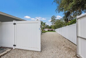 Side drive currently has a boat and trailer parked behind the gate.