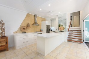 Light and open kitchen that connects to the outdoor BBQ area