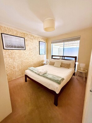 Yellow bedroom with Queen bed, ducted aircon and wardrobe