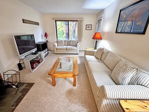 Living room includes door to covered porch