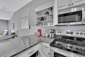 The kitchen includes cups, appliances to make this a home away from home