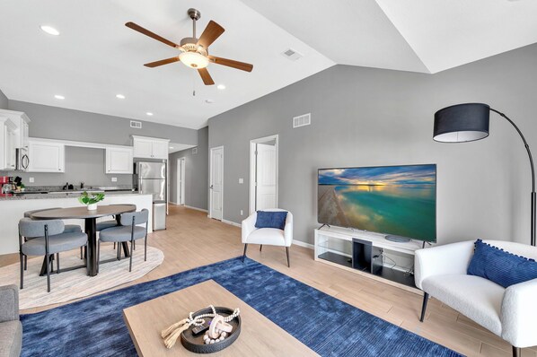 The open floor living and dining space blen with the kitchen to offer natural light and a seamless transition between spaces