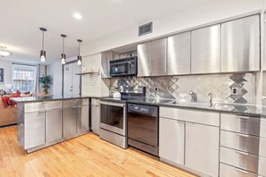 An open concept stylish kitchen with stainless steel appliances