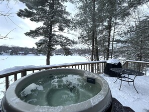 Come soak in the hot tub overlooking the lake while the snow falls around you!