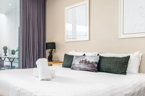 Experience ultimate comfort on a king-size bed, featuring freshly laundered linens for a pristine and restful sleep.