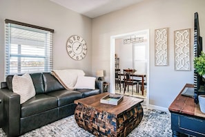 As you enter the living room, you'll find a cozy and welcoming space perfect for relaxation. The living room effortlessly connects to the adjacent dining area, ideal for socializing or enjoying some quiet downtime.