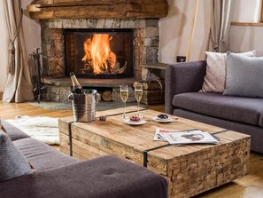 Take a seat in front of the fireplace and enjoy the living area.