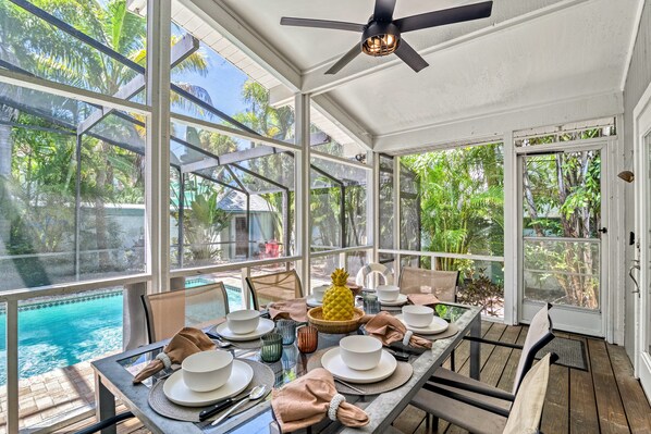 Screened in Lanai with dining table for six overlooking the pool and yard.