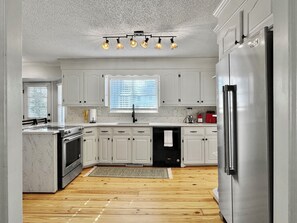 Your kitchen is fully stocked with utensils and cooking essentials.