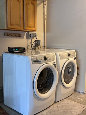 Shared laundry facilities just outside the studio door in the garage. 
We provide laundry pods for you to use. 
