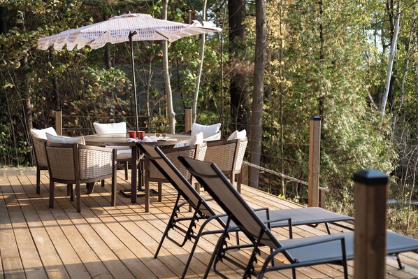 Beautiful deck overlooking the water. Please note that our hot tub is now located where the dining table is. 