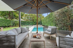 Relax in style with comfortable outdoor seating perfectly positioned by the pool. A serene spot to unwind, soak up the sun, and enjoy the ultimate poolside retreat.
