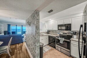 The fully equipped kitchen features granite countertops, updated cabinets & appliances, and has everything you need to prepare meals for family & friends.