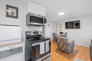 Kitchen is stocked with utensils and cookware to prepare meals.