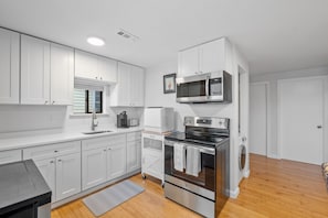 Kitchen equipped with modern appliances.
