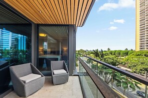 Modern outdoor retreat with cozy chairs and lush surroundings.