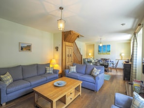 Open plan living / dining room, 2 sofas, coffee table, table and 6 chairs, stairs