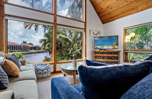 Relax in a cozy living room that offers panoramic water views