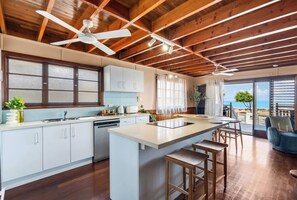 Prepare meals with ease in the fully-equipped kitchen, featuring modern appliances and a breakfast bar.