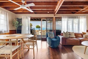 Sliding doors extend from the living area to the beachfront deck.