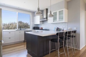 A fully-equipped kitchen with a modern layout and expansive views, perfect for preparing family meals.
